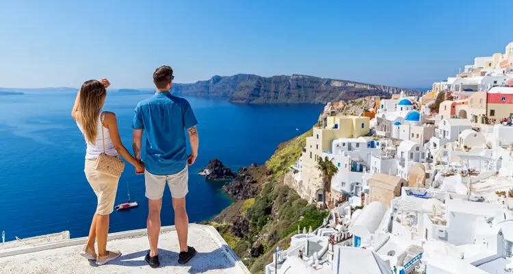 Young couple on the roof of the building in Santorini, Greece